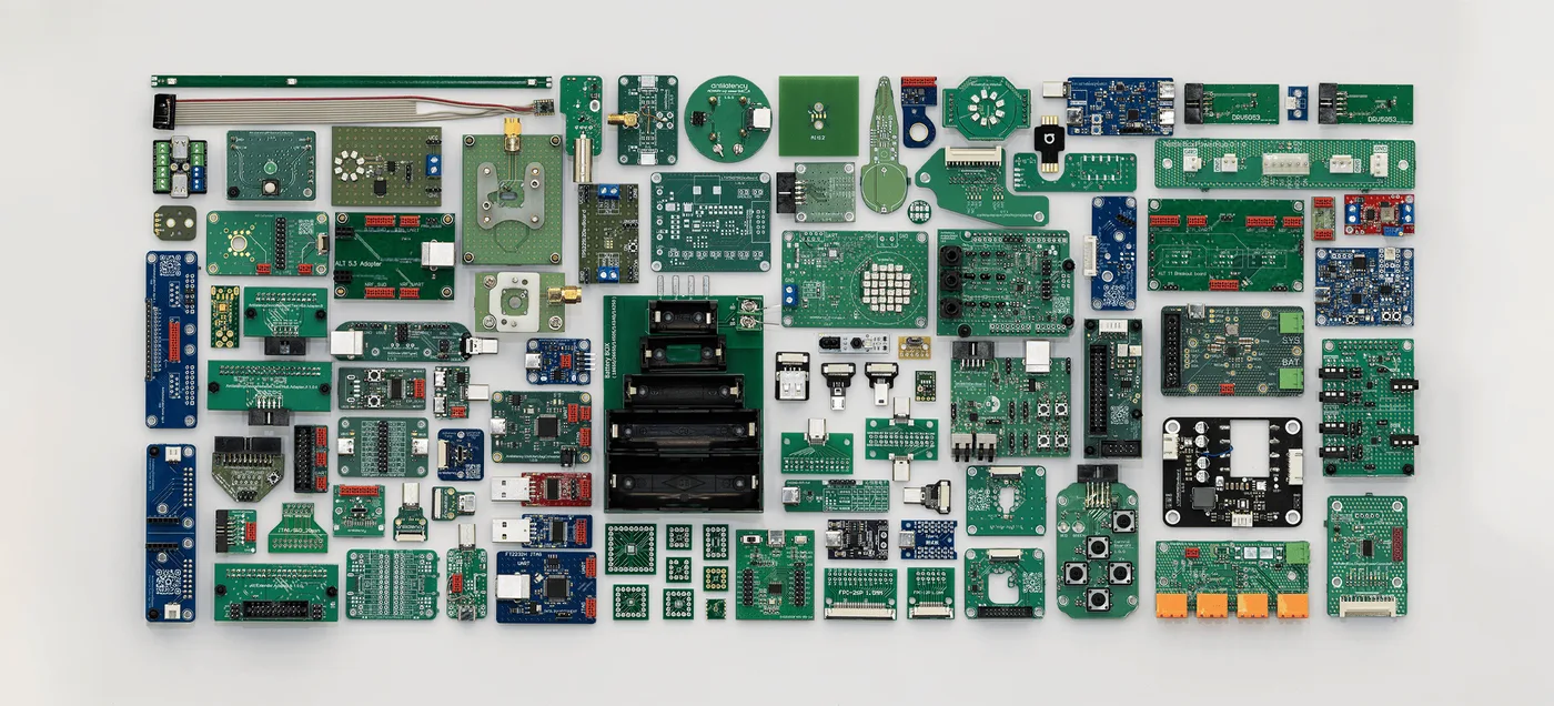 A collection of adapter boards, breakout boards, test jigs, and engineering helpers