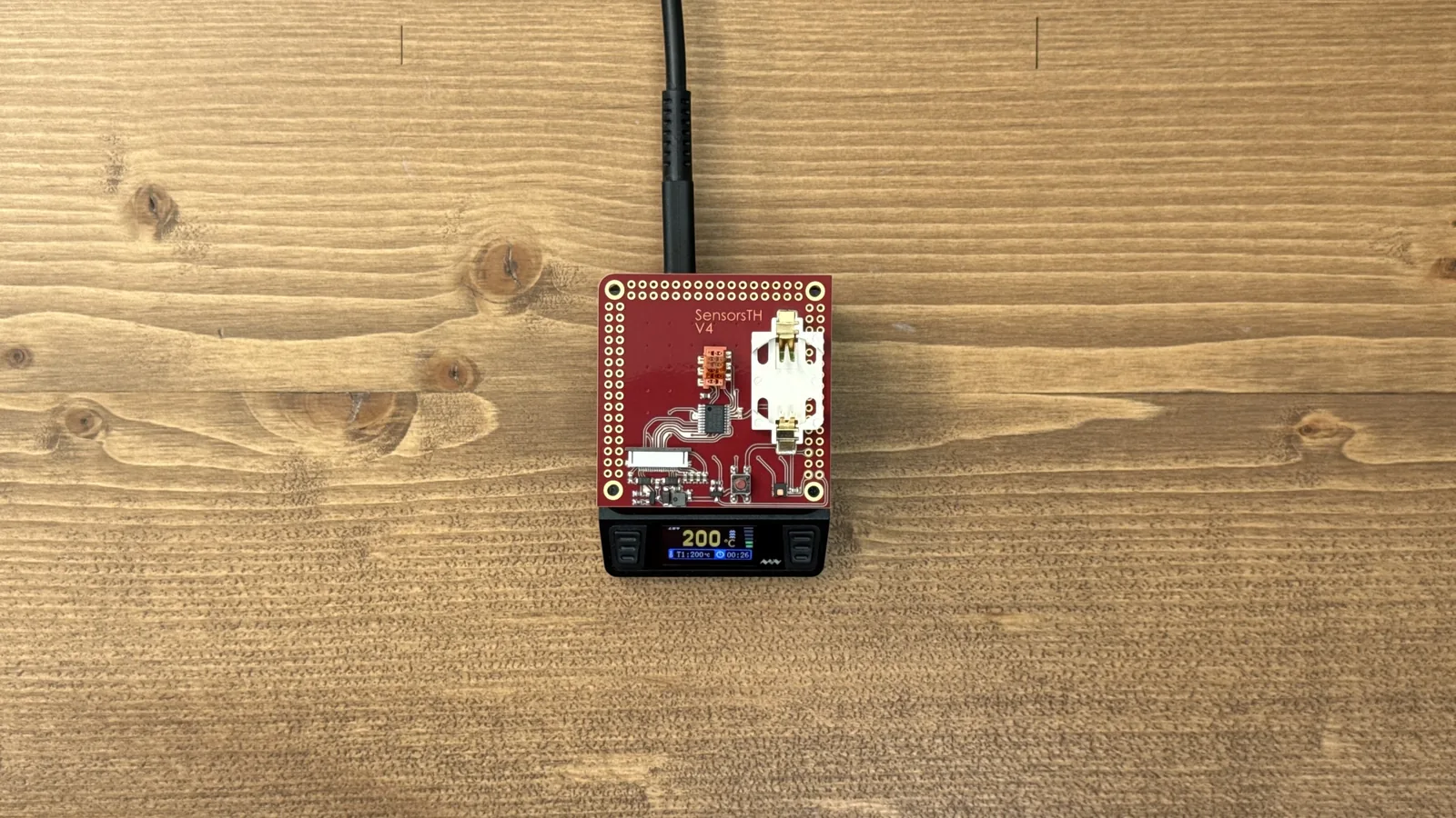 A freshly assembled PCB reflowing on a small hot plate