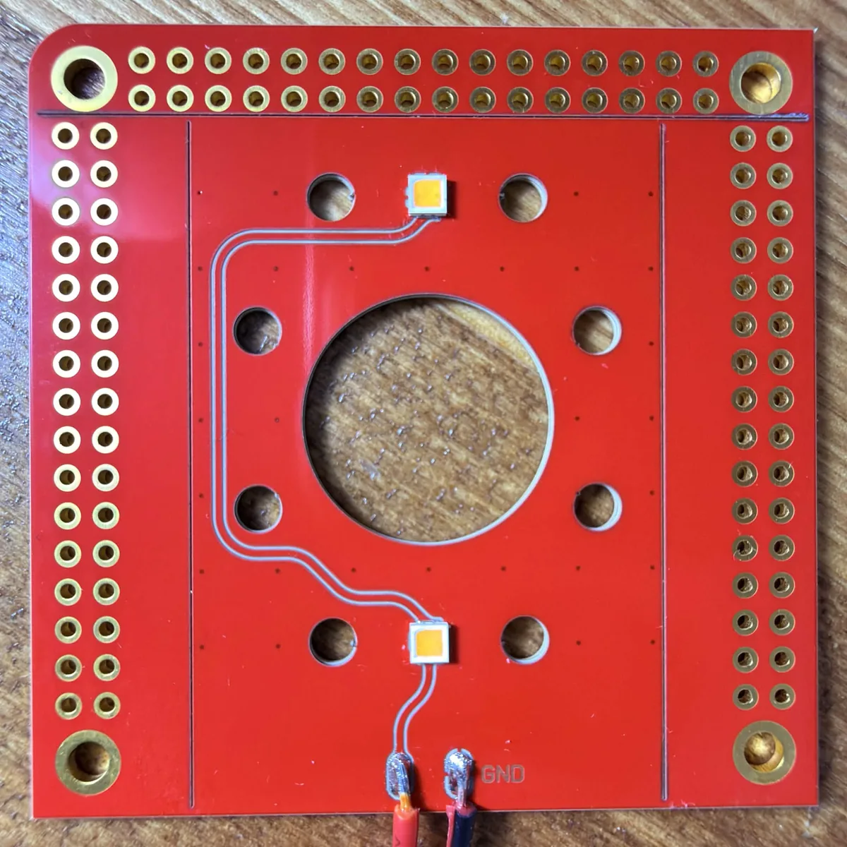 A ceramic LED board with cutouts before snap separation